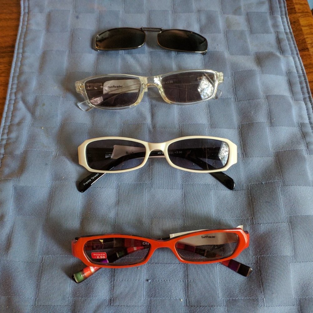 3 pairs of reading sunglasses,  2 of them power 2.0, 1 of power 2.5